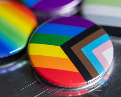 a close up of a rainbow colored button