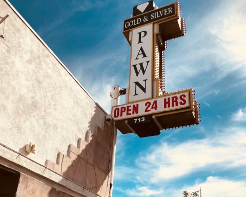 a sign that says pawn pawn on the side of a building
