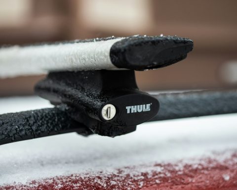 a close up of the handle of a car covered in snow