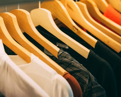 clothes hanged on brown wooden hanger