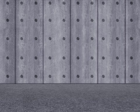 Moderne keuken met industriële betonlook muur en donkere houten accenten